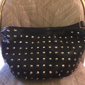 New black purse with gold studs.