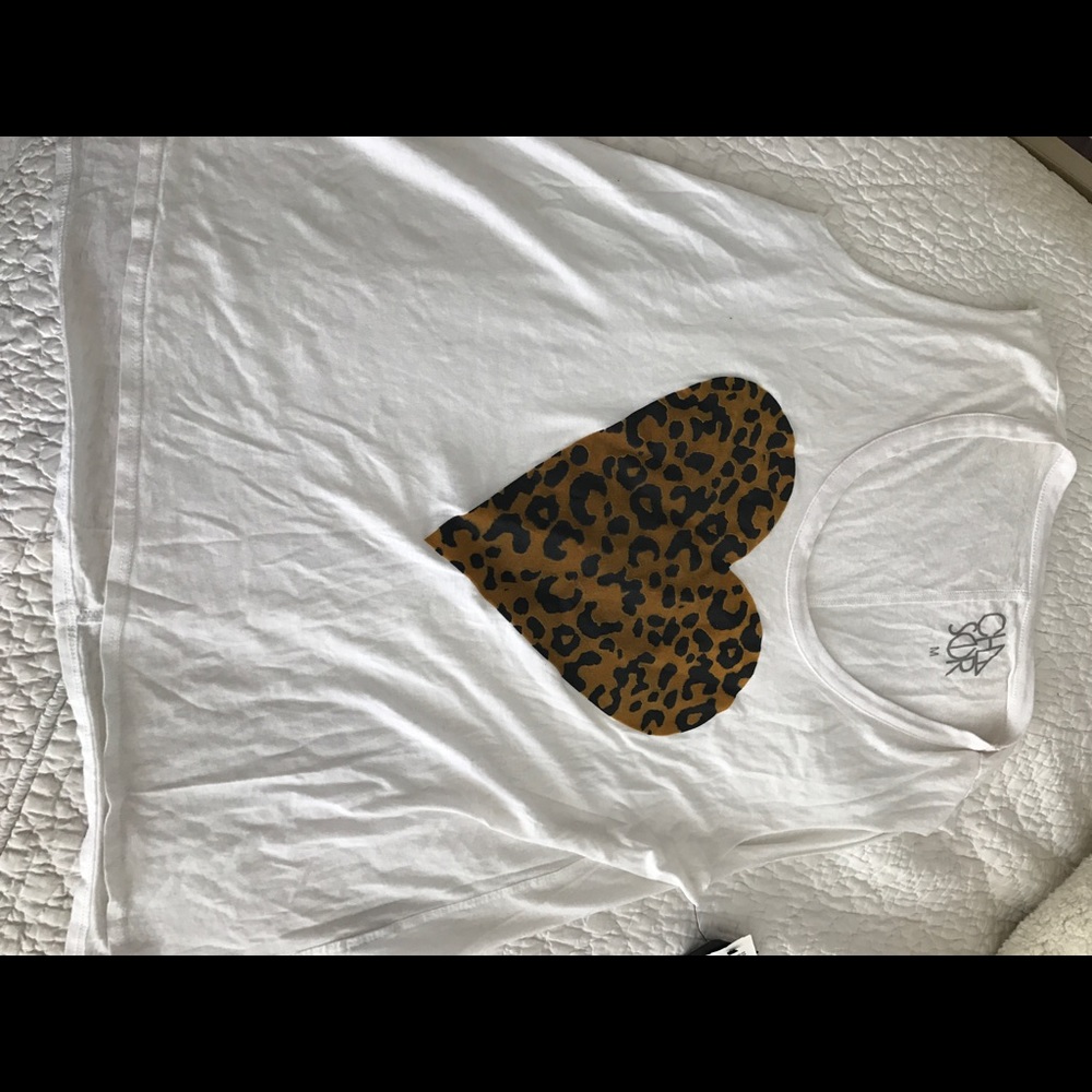 White sleeveless tee with leopard heart pattern.