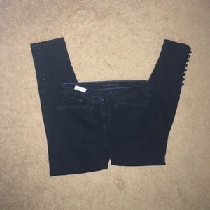 Black skinny jeans with buttons