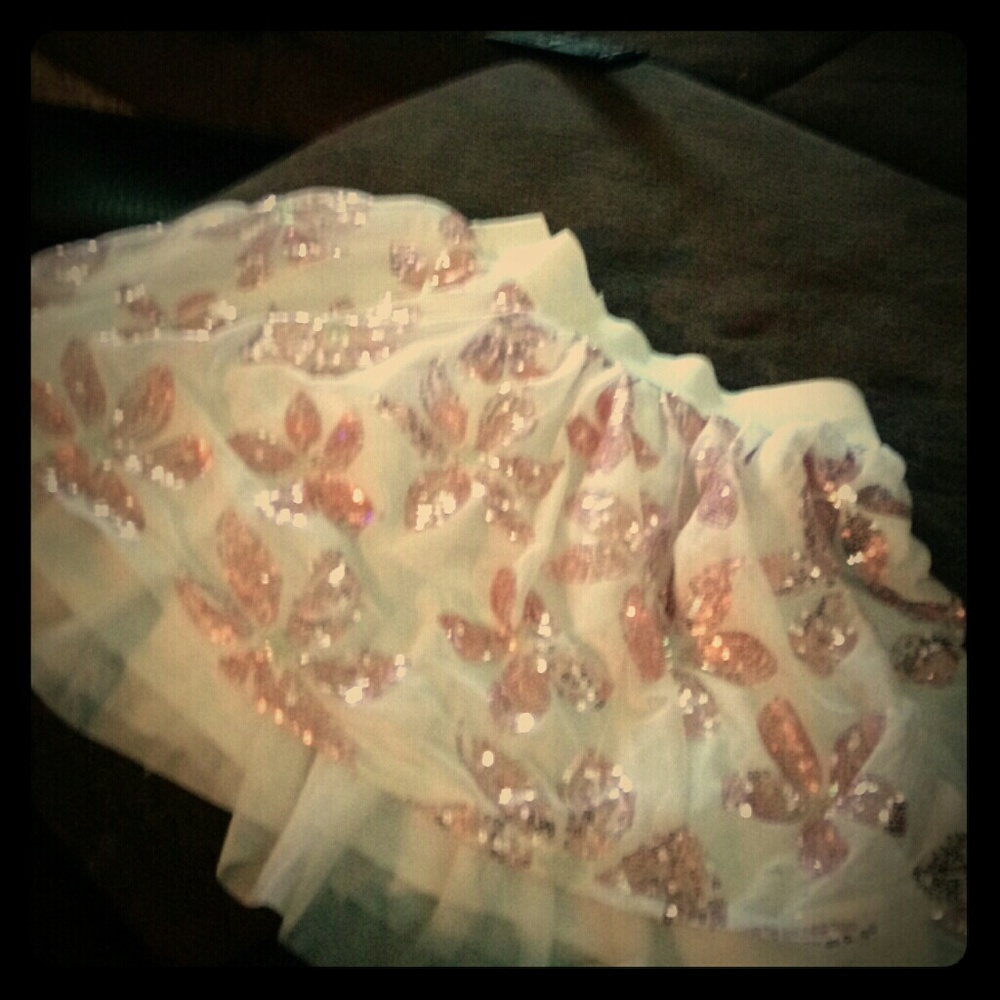 A classy white skirt with sequin flowers.