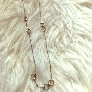 Silver necklace with circle accents.