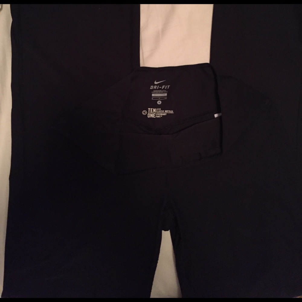 NIKE DRI-FIT black wide-leg athletic pant.