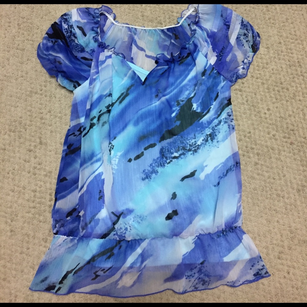 Silky blue and white blouse .