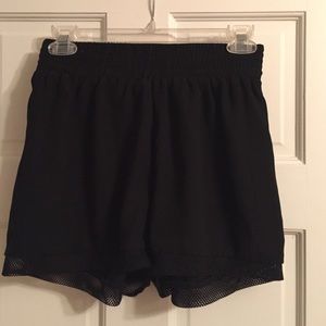 Black shorts with mesh detail at the hem
