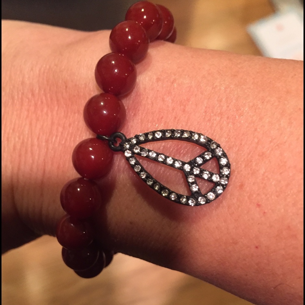 A stretch carnelian bracelet with peace charm