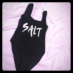 Black one piece with word " SALT"