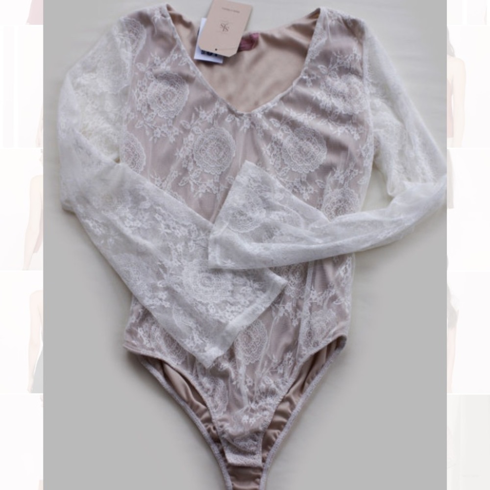 Off-white lace body suit with bell sleeves