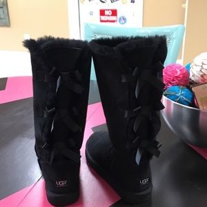 Black tall ugg boots with bows
