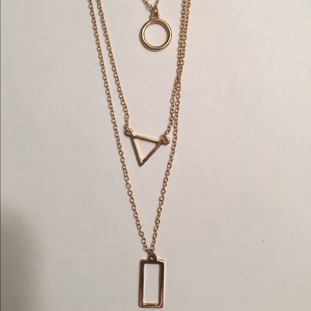 Gold costume necklace with 3 layer shapes
