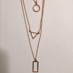 Gold costume necklace with 3 layer shapes