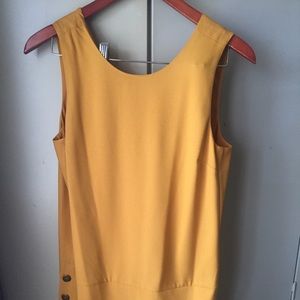Mustard color dress with side buttons.