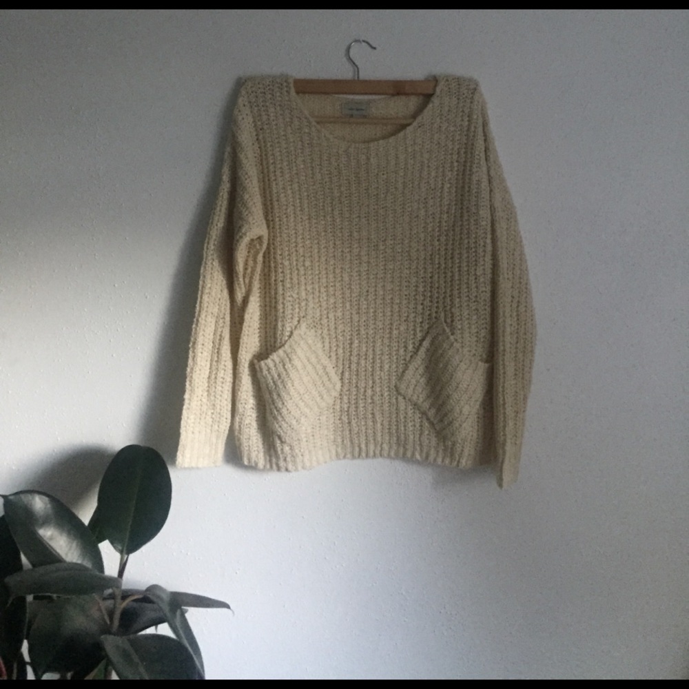 Slouchy knit sweater w/ front pockets.