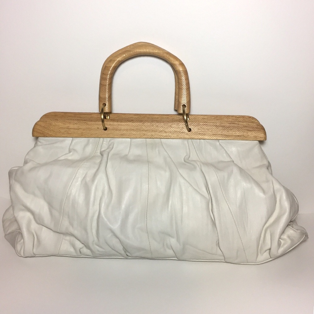 Off white leather hobo bag with wooden handles.