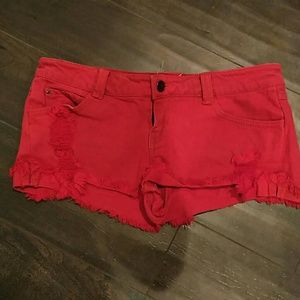 Distressed red jean shorts