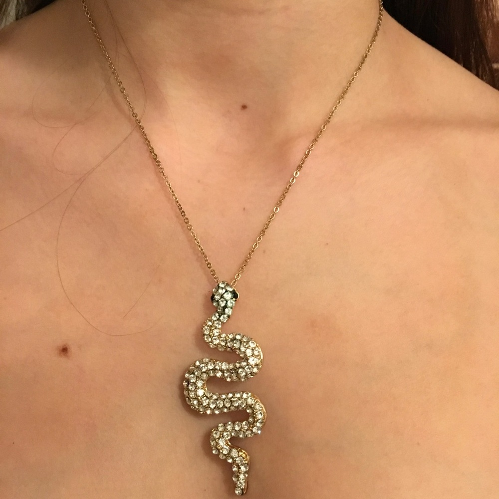 Crystal snake pendant on gold chain.