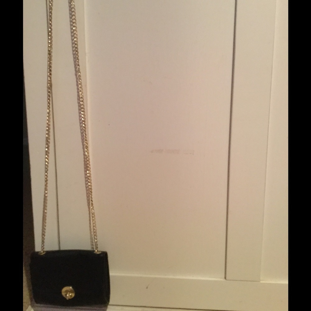 Small elegant black purse with gold chain strap