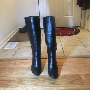 Tall black wedge pointed boots