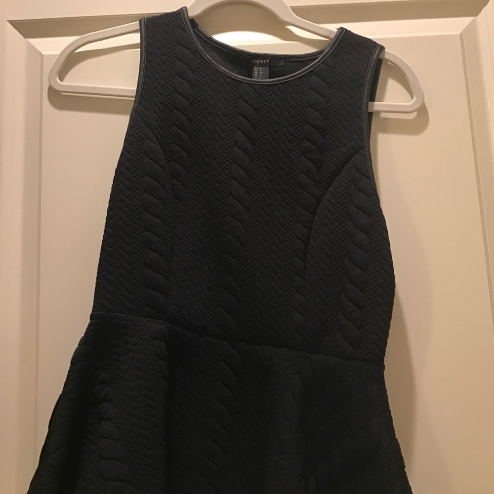 Black peplum top with leather trim