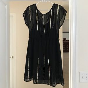 Black dress with gold and black sequins detail.