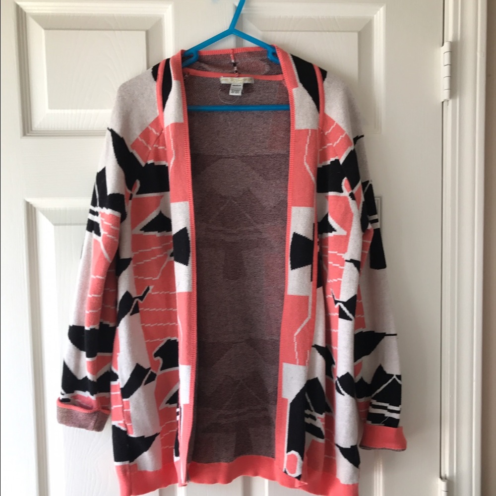 Coral and black geometric patterned sweater