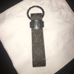Louis Vuitton brown leather key holder accessory.
