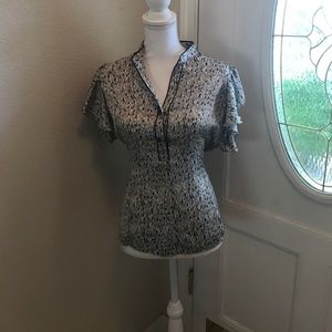Very cute black/gold print shirt. Size M