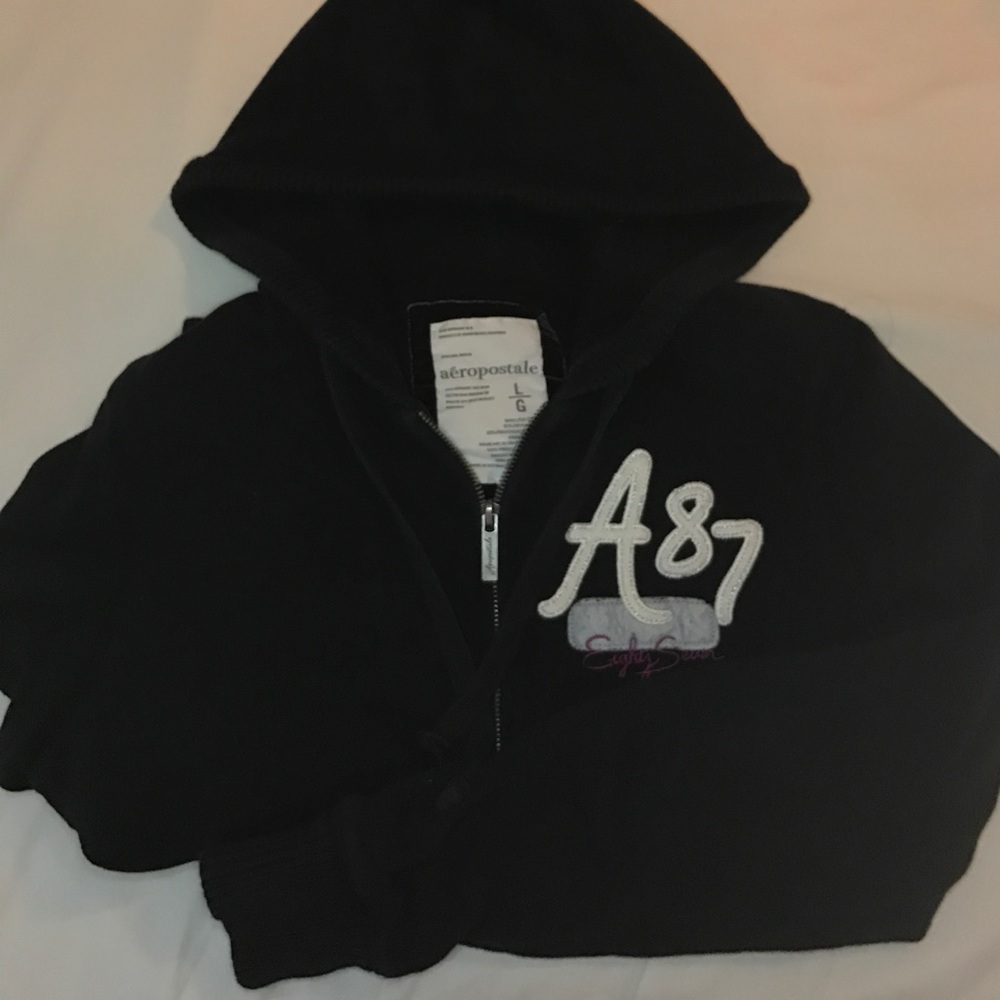 Zip up black hoodie has a slight faded look
