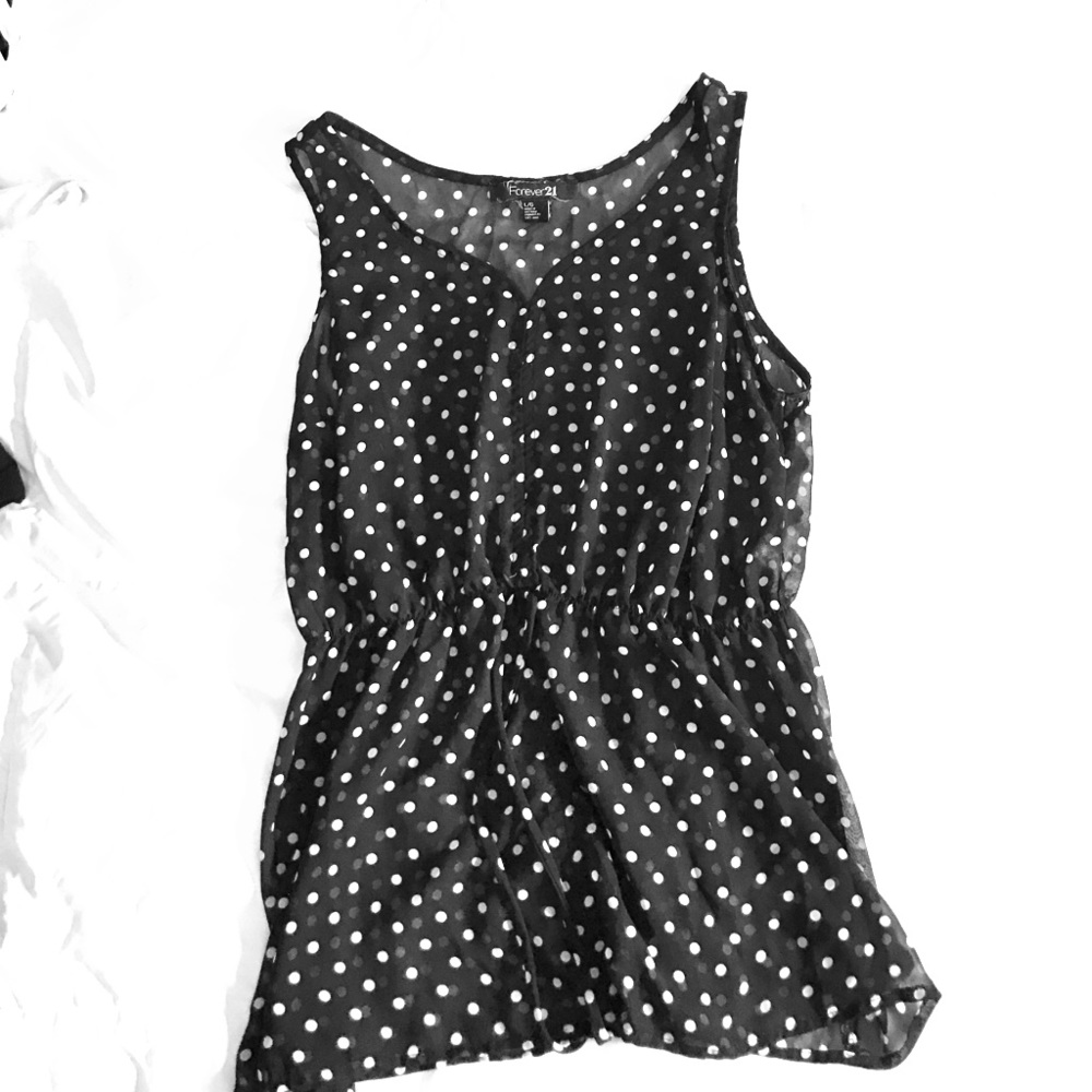 Black and white polka dot sleeveless shirt.