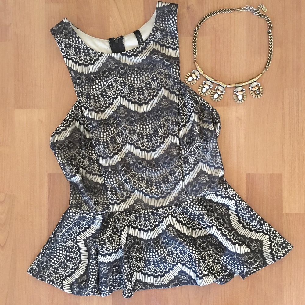 Cream peplum with black lace overlay