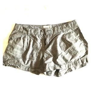 Pleated grey shorts.