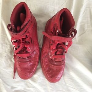Red high top strapped pumas