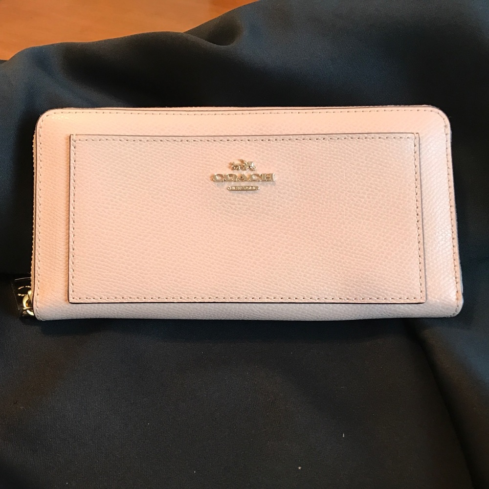 Light pink leather Coach wallet.