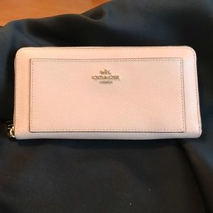 Light pink leather Coach wallet.