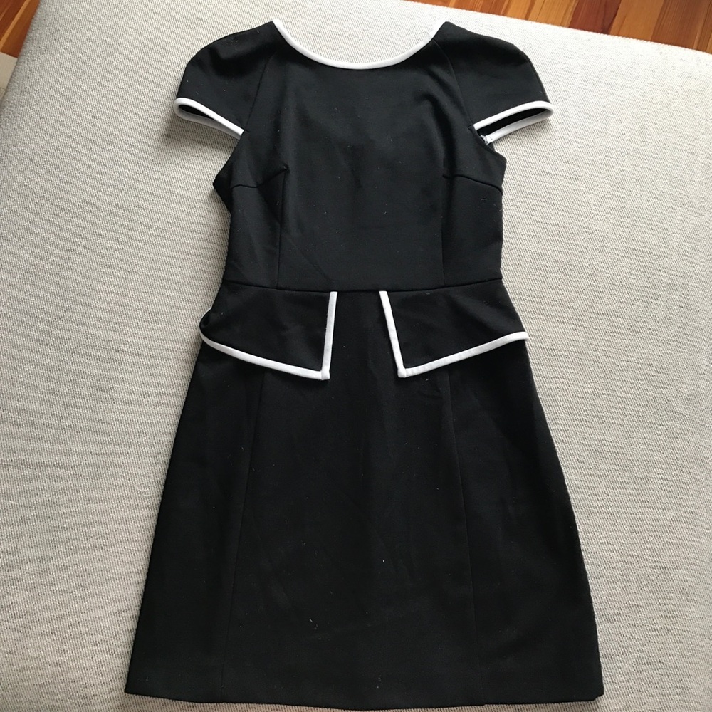 Black dress with white trim a peplum detail