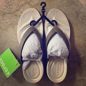 Leather flip flop crocs.