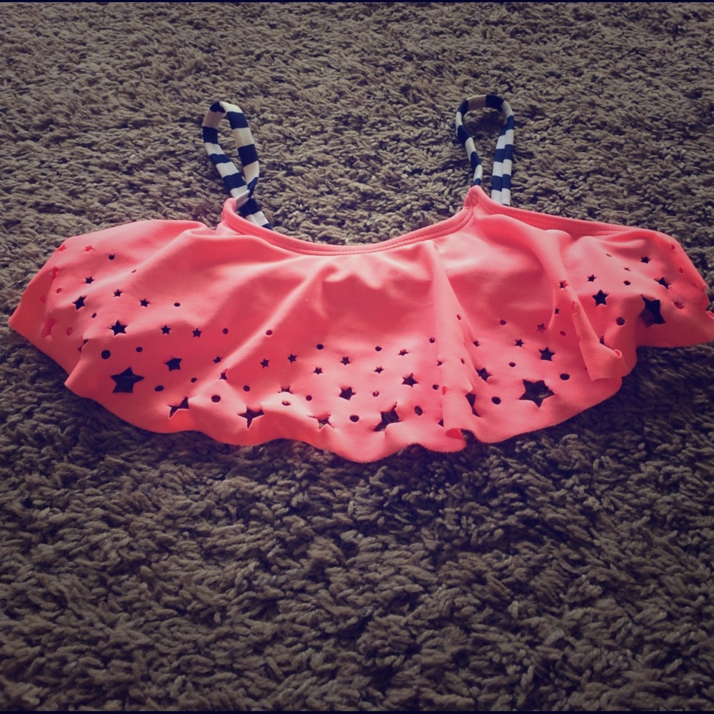 A bikini top with a pink front and stars cut out