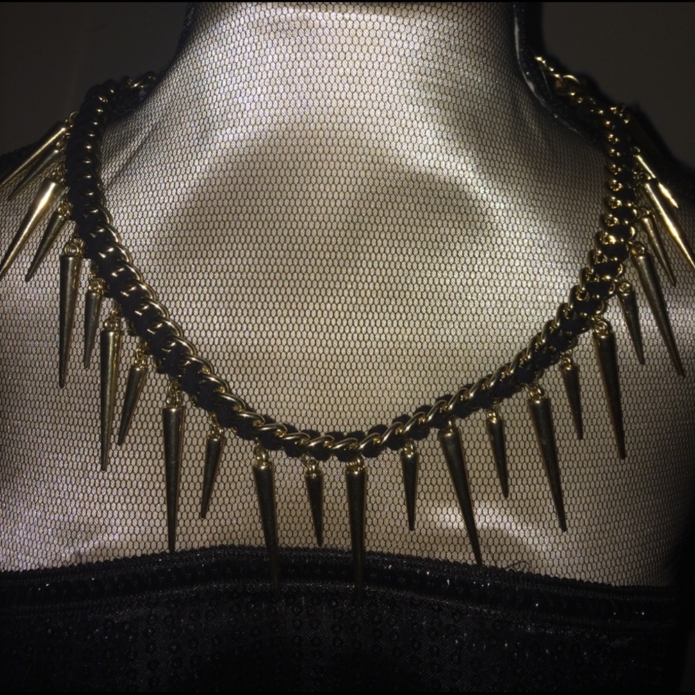 Gold and black spiked necklace.