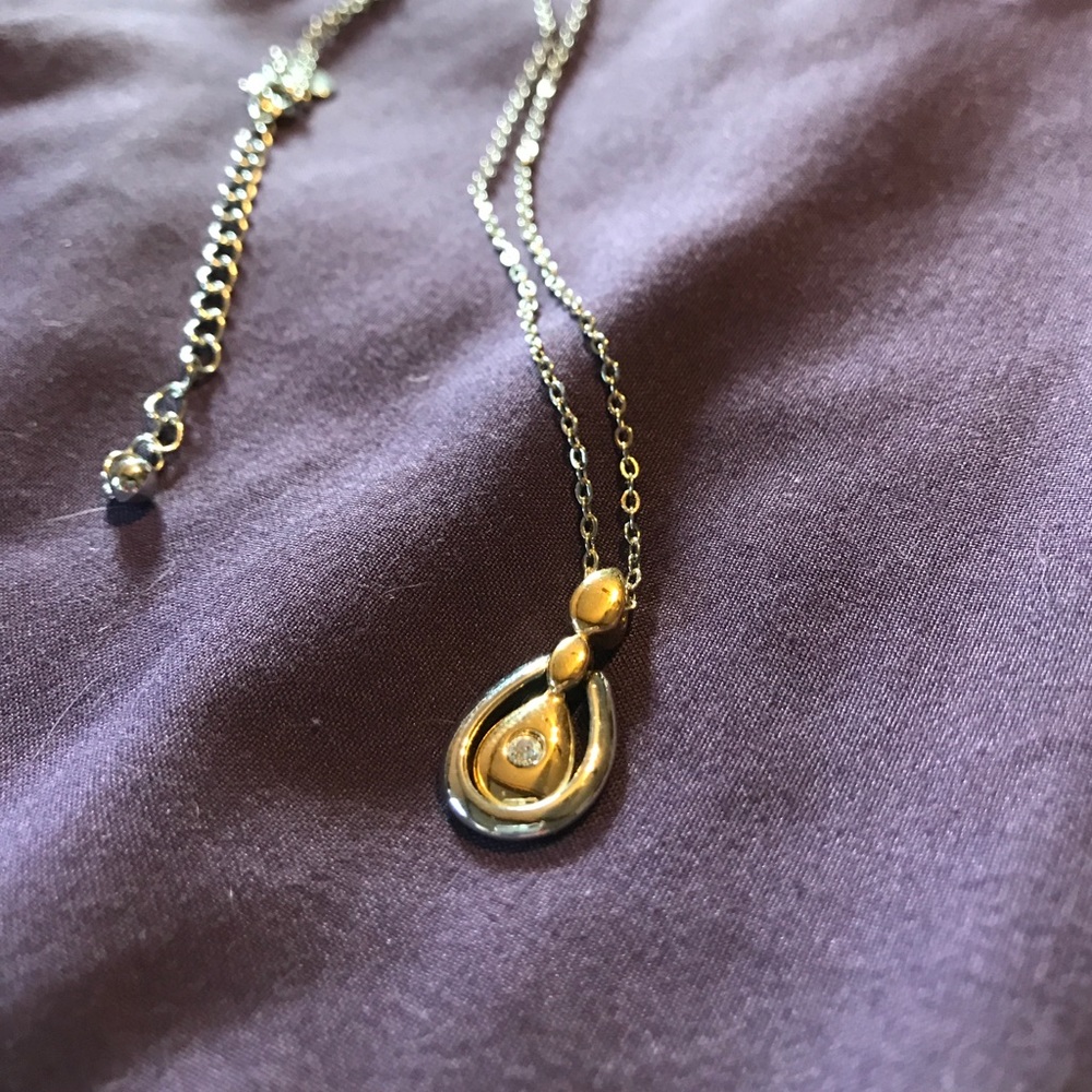 Gold and silver pendant on a silver adj chain