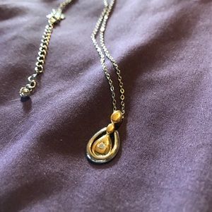Gold and silver pendant on a silver adj chain