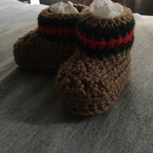 Crocheted booties with Gucci print.