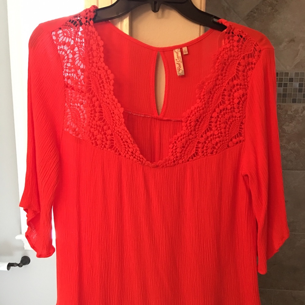 Orange top with crocheted detail. Only worn once.