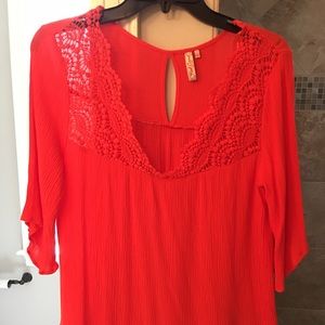 Orange top with crocheted detail. Only worn once.