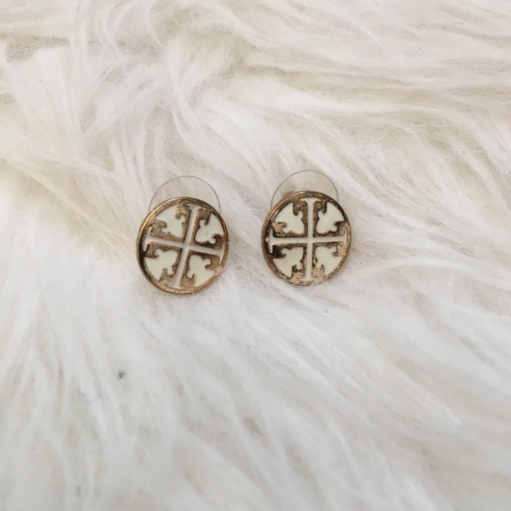 Gold and white stud earrings.