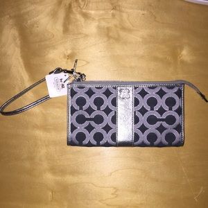 Coach wristlet with metallic C design