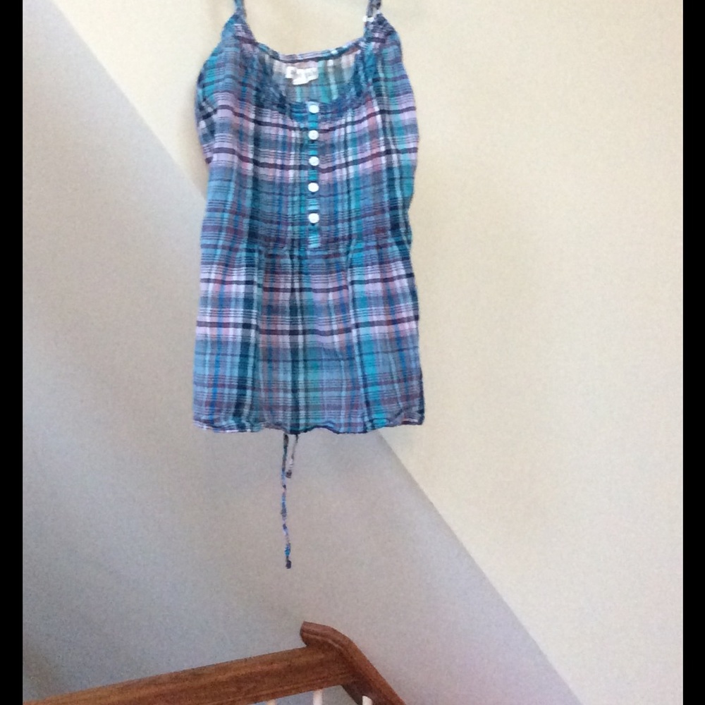 Colorful tank top that has a bow in the back .