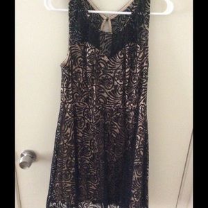 Knee length black and beige lace dress.