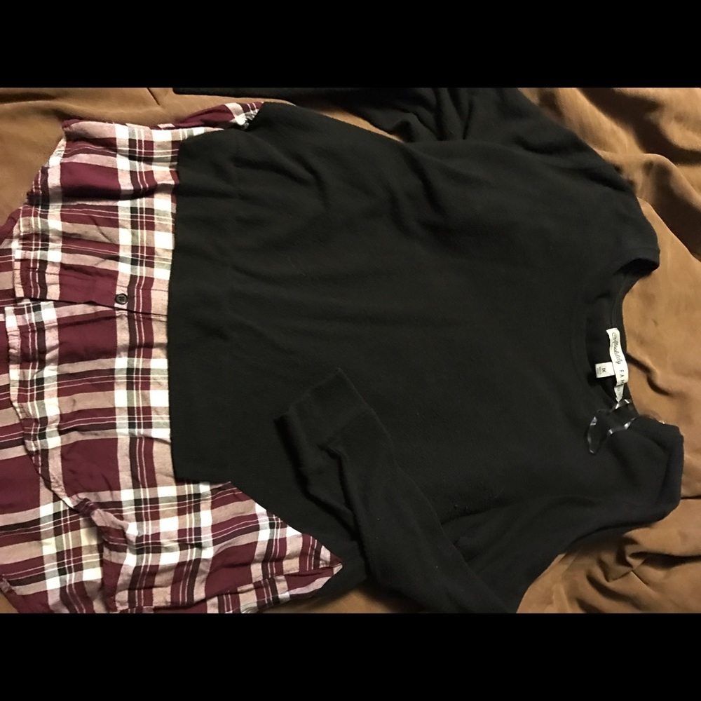 Black blouse with plaid detail attached.