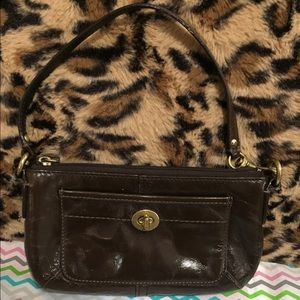 Gently used brown patent coach wristlet