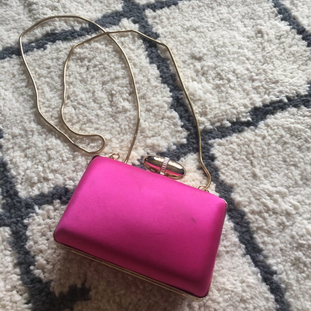 Pink clutch with optional gold strap.