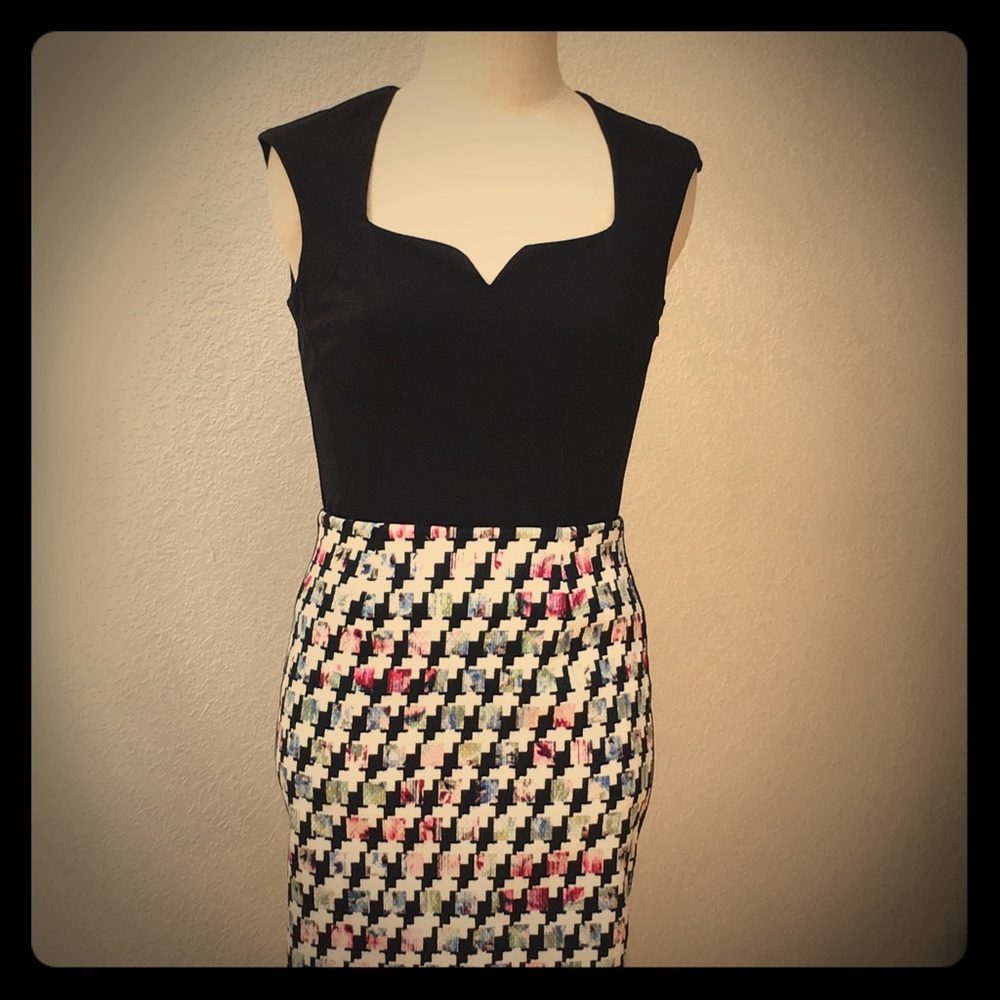 Knee length skirt and black sweetheart tank top.